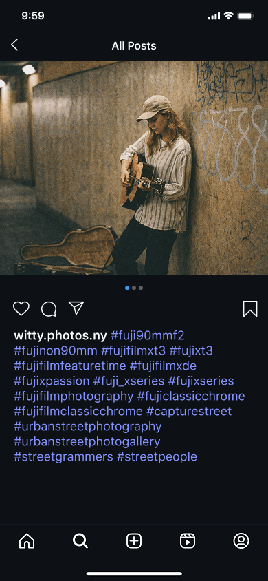 An Instagram photo of a young woman playing guitar on the street and film photography hashtags
